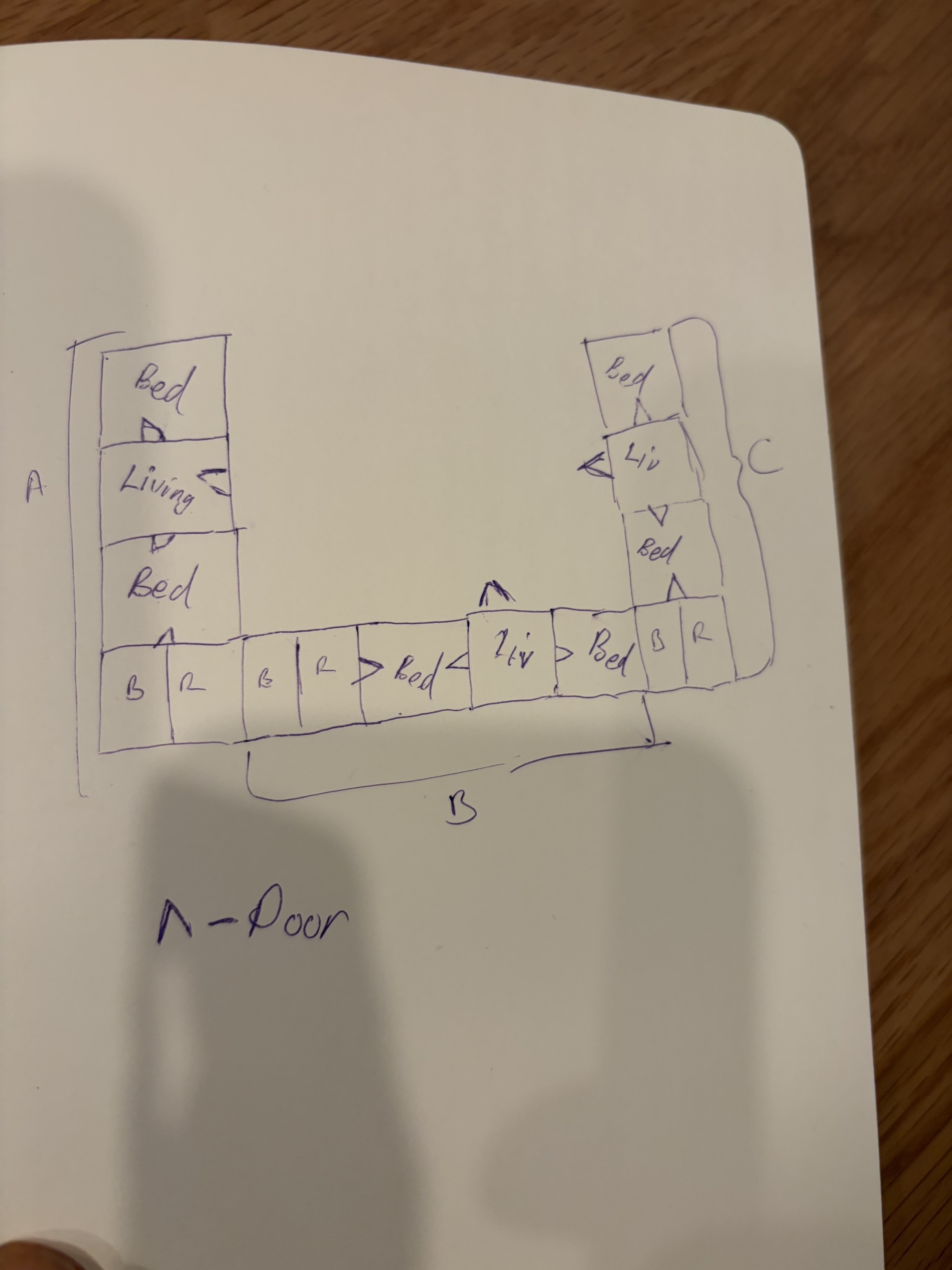 Hand-drawn house plan sketch on paper